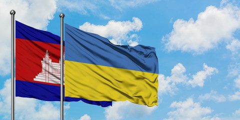 Cambodia and Ukraine flag waving in the wind against white cloudy blue sky together. Diplomacy concept, international relations.