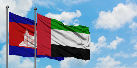 Cambodia and United Arab Emirates flag waving in the wind against white cloudy blue sky together. Diplomacy concept, international relations.