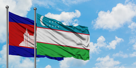 Cambodia and Uzbekistan flag waving in the wind against white cloudy blue sky together. Diplomacy concept, international relations.