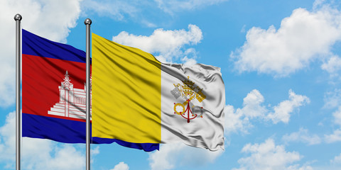 Cambodia and Vatican City flag waving in the wind against white cloudy blue sky together. Diplomacy concept, international relations.