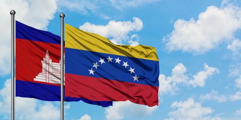 Cambodia and Venezuela flag waving in the wind against white cloudy blue sky together. Diplomacy concept, international relations.