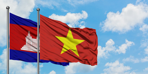 Cambodia and Vietnam flag waving in the wind against white cloudy blue sky together. Diplomacy concept, international relations.