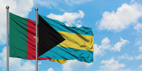 Cameroon and Bahamas flag waving in the wind against white cloudy blue sky together. Diplomacy concept, international relations.