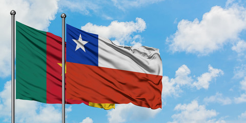 Cameroon and Chile flag waving in the wind against white cloudy blue sky together. Diplomacy concept, international relations.