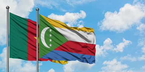 Cameroon and Comoros flag waving in the wind against white cloudy blue sky together. Diplomacy concept, international relations.