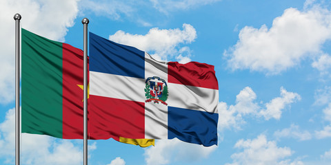 Cameroon and Dominican Republic flag waving in the wind against white cloudy blue sky together. Diplomacy concept, international relations.