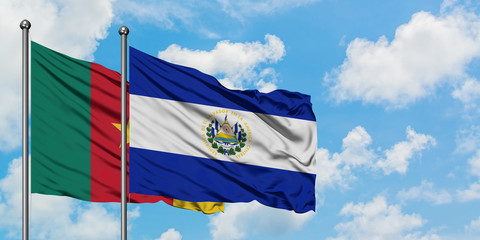 Cameroon and El Salvador flag waving in the wind against white cloudy blue sky together. Diplomacy concept, international relations.