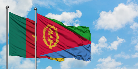 Cameroon and Eritrea flag waving in the wind against white cloudy blue sky together. Diplomacy concept, international relations.