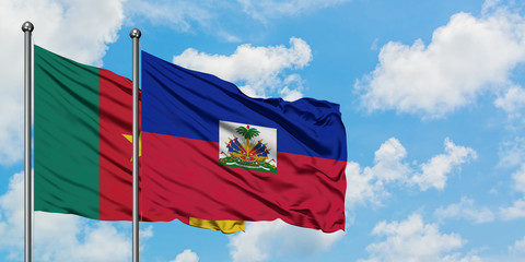 Cameroon and Haiti flag waving in the wind against white cloudy blue sky together. Diplomacy...