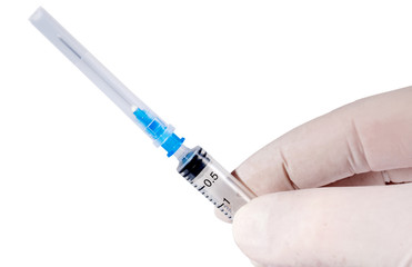 Obraz premium Hand in a medical glove with a syringe