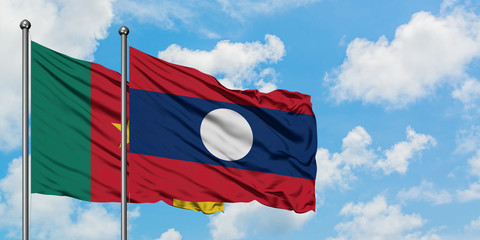 Cameroon and Laos flag waving in the wind against white cloudy blue sky together. Diplomacy concept, international relations.