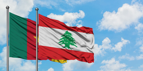 Cameroon and Lebanon flag waving in the wind against white cloudy blue sky together. Diplomacy concept, international relations.