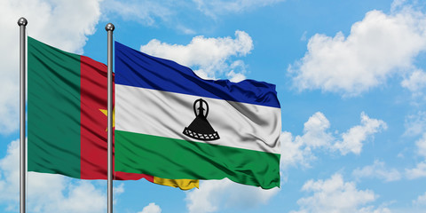 Cameroon and Lesotho flag waving in the wind against white cloudy blue sky together. Diplomacy concept, international relations.