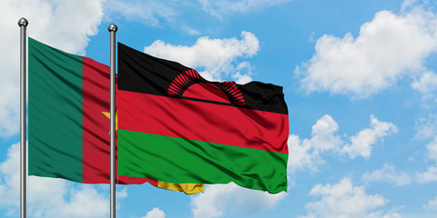 Cameroon and Malawi flag waving in the wind against white cloudy blue sky together. Diplomacy concept, international relations.