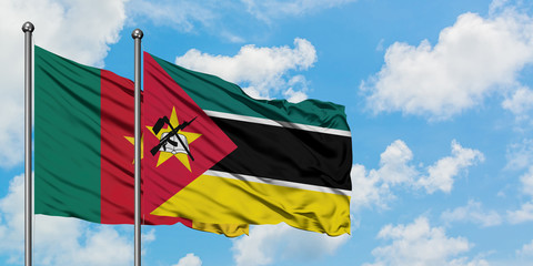 Cameroon and Mozambique flag waving in the wind against white cloudy blue sky together. Diplomacy concept, international relations.