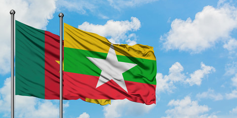 Cameroon and Myanmar flag waving in the wind against white cloudy blue sky together. Diplomacy concept, international relations.