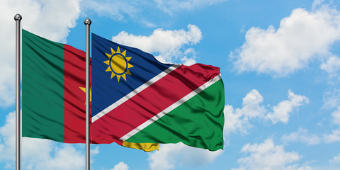 Cameroon and Namibia flag waving in the wind against white cloudy blue sky together. Diplomacy concept, international relations.