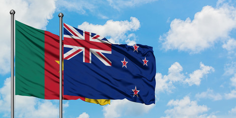 Cameroon and New Zealand flag waving in the wind against white cloudy blue sky together. Diplomacy concept, international relations.