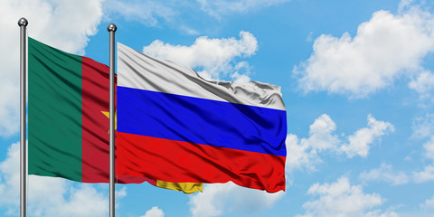 Cameroon and Russia flag waving in the wind against white cloudy blue sky together. Diplomacy concept, international relations.