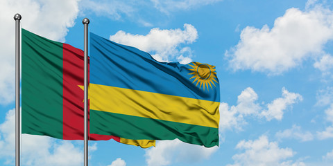 Cameroon and Rwanda flag waving in the wind against white cloudy blue sky together. Diplomacy concept, international relations.