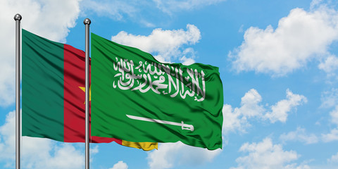 Cameroon and Saudi Arabia flag waving in the wind against white cloudy blue sky together. Diplomacy concept, international relations.