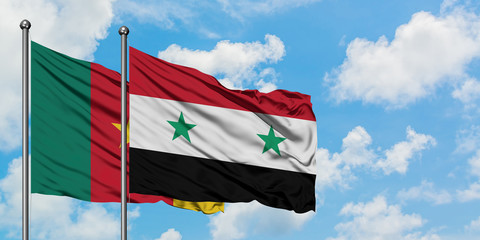 Cameroon and Syria flag waving in the wind against white cloudy blue sky together. Diplomacy concept, international relations.