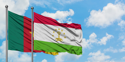 Cameroon and Tajikistan flag waving in the wind against white cloudy blue sky together. Diplomacy concept, international relations.