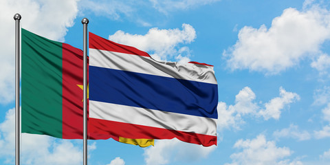 Cameroon and Thailand flag waving in the wind against white cloudy blue sky together. Diplomacy concept, international relations.