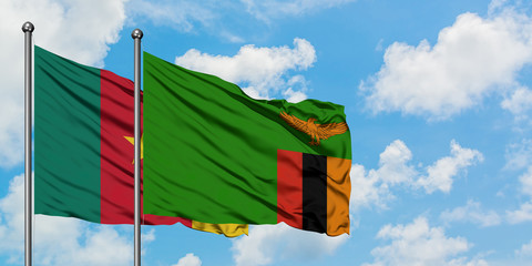 Cameroon and Zambia flag waving in the wind against white cloudy blue sky together. Diplomacy concept, international relations.