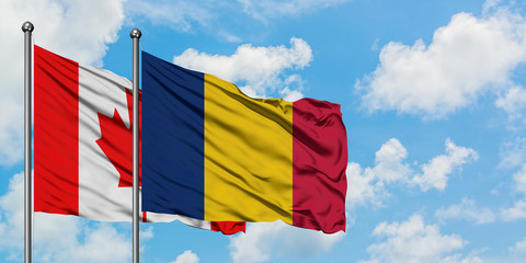 Canada and Chad flag waving in the wind against white cloudy blue sky together. Diplomacy concept, international relations.