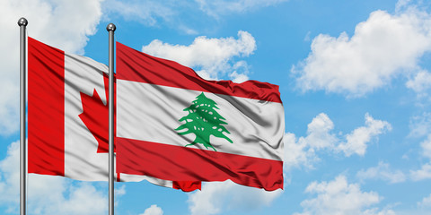 Canada and Lebanon flag waving in the wind against white cloudy blue sky together. Diplomacy concept, international relations.