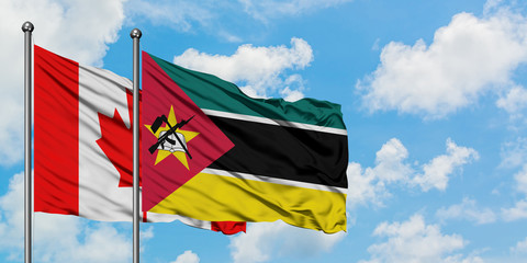 Canada and Mozambique flag waving in the wind against white cloudy blue sky together. Diplomacy concept, international relations.