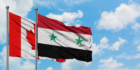 Canada and Syria flag waving in the wind against white cloudy blue sky together. Diplomacy concept,...