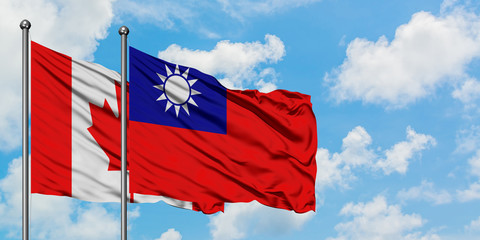 Canada and Taiwan flag waving in the wind against white cloudy blue sky together. Diplomacy concept, international relations.