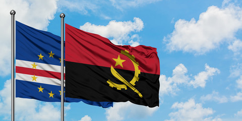 Cape Verde and Angola flag waving in the wind against white cloudy blue sky together. Diplomacy concept, international relations.