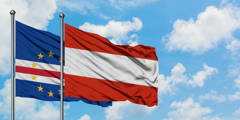 Cape Verde and Austria flag waving in the wind against white cloudy blue sky together. Diplomacy concept, international relations.