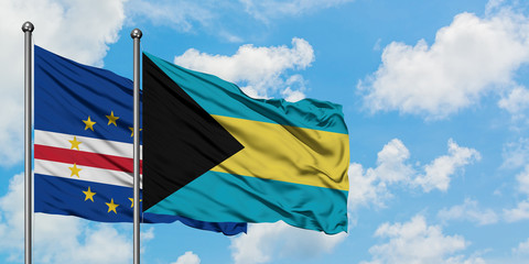 Cape Verde and Bahamas flag waving in the wind against white cloudy blue sky together. Diplomacy concept, international relations.
