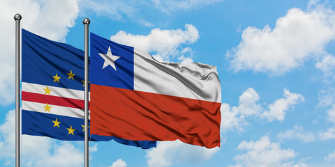 Cape Verde and Chile flag waving in the wind against white cloudy blue sky together. Diplomacy concept, international relations.