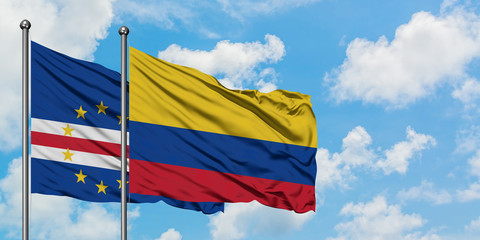 Cape Verde and Colombia flag waving in the wind against white cloudy blue sky together. Diplomacy concept, international relations.