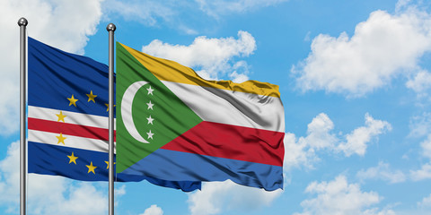 Cape Verde and Comoros flag waving in the wind against white cloudy blue sky together. Diplomacy concept, international relations.