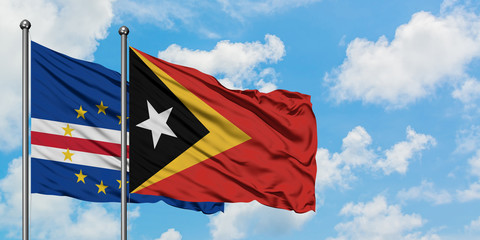 Cape Verde and East Timor flag waving in the wind against white cloudy blue sky together. Diplomacy concept, international relations.