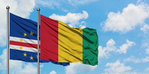 Cape Verde and Guinea flag waving in the wind against white cloudy blue sky together. Diplomacy concept, international relations.