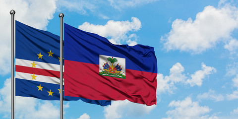 Cape Verde and Haiti flag waving in the wind against white cloudy blue sky together. Diplomacy concept, international relations.