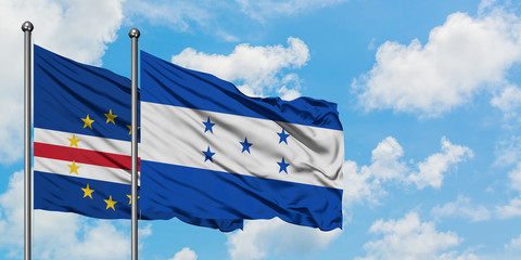 Cape Verde and Honduras flag waving in the wind against white cloudy blue sky together. Diplomacy concept, international relations.