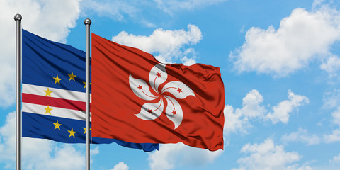 Cape Verde and Hong Kong flag waving in the wind against white cloudy blue sky together. Diplomacy concept, international relations.