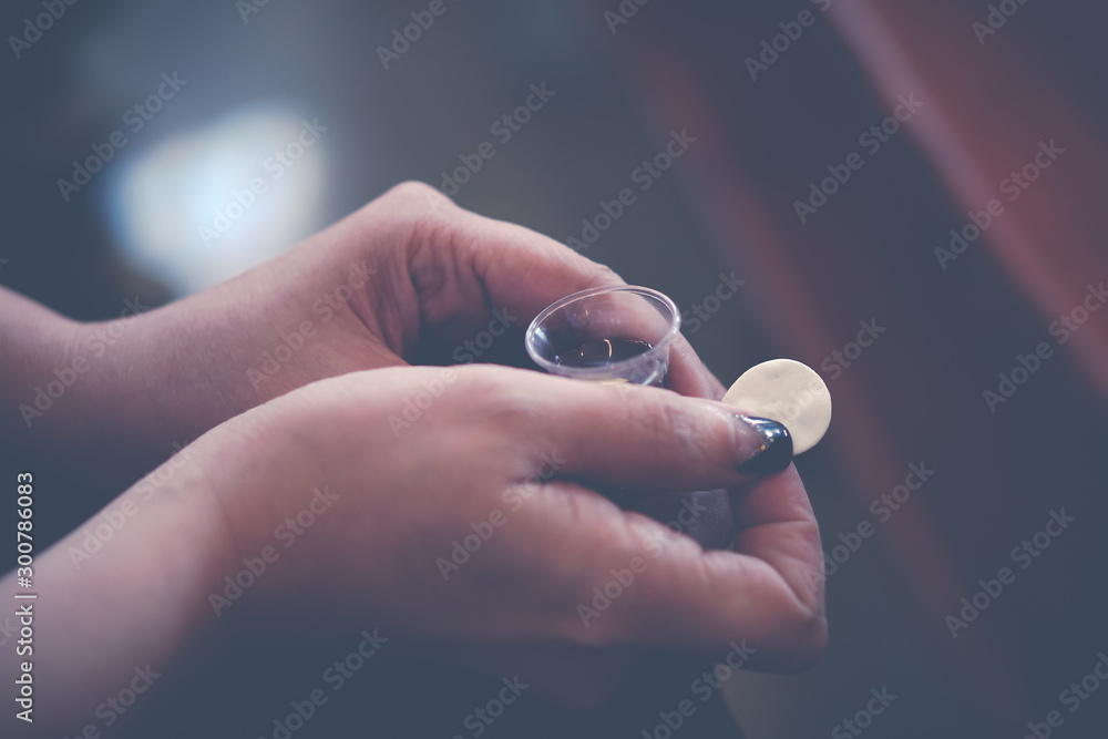 Wall mural Woman holding wine in a Holy communion.