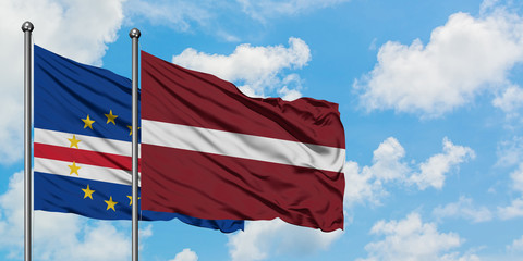 Cape Verde and Latvia flag waving in the wind against white cloudy blue sky together. Diplomacy concept, international relations.