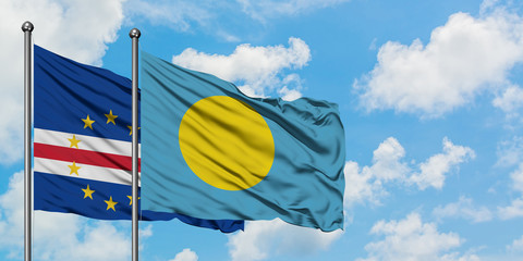 Cape Verde and Palau flag waving in the wind against white cloudy blue sky together. Diplomacy concept, international relations.