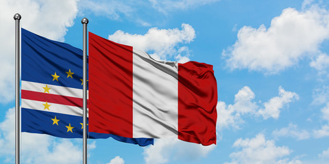 Cape Verde and Peru flag waving in the wind against white cloudy blue sky together. Diplomacy concept, international relations.