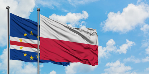 Cape Verde and Poland flag waving in the wind against white cloudy blue sky together. Diplomacy concept, international relations.